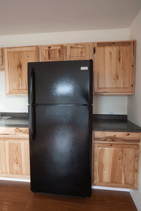 A full size refrigerator in the kitchen
