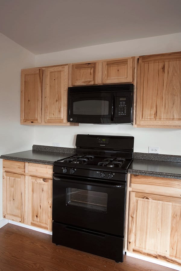 A full size stove and microwave in the kitchen